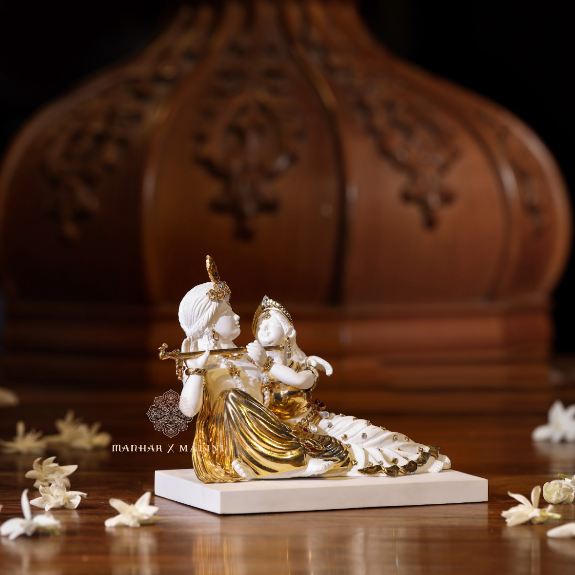 Radha Krishna (sitting)
